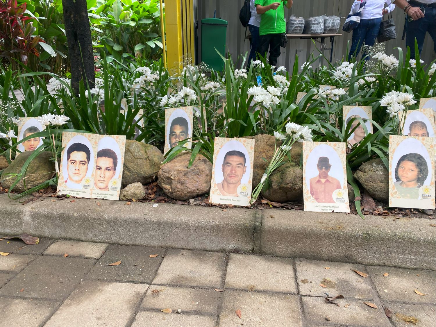 Nine of several photos are displayed of loved ones by the organization Madres de la Candelaria